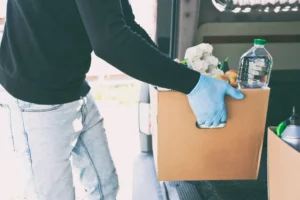 a person holding a box of food