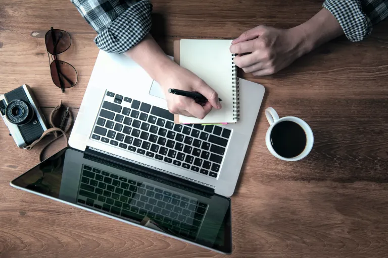 a person writing on a notebook