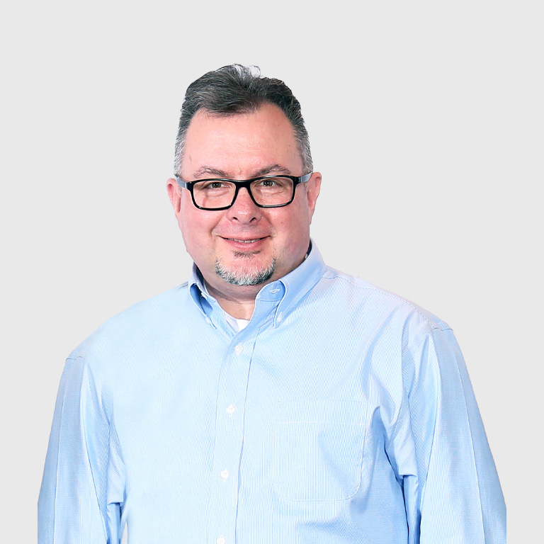 a man wearing glasses and a blue shirt