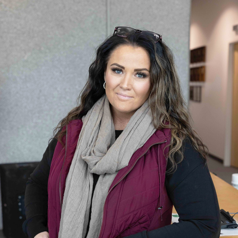 a woman wearing a scarf and a vest